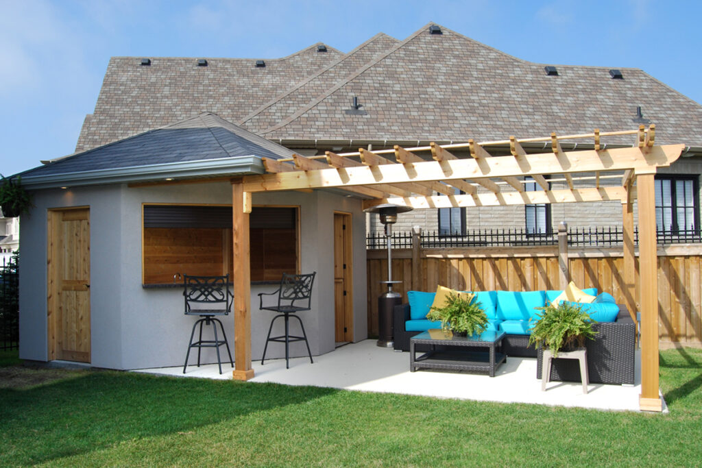 Cedar pergola extending from a pool cabana to shade a bar and seating area