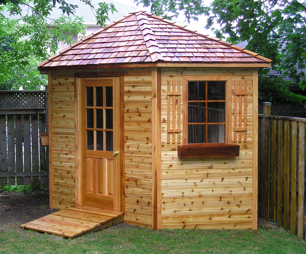 Cedar shed with hip roof of cedar shakes and a flower box
