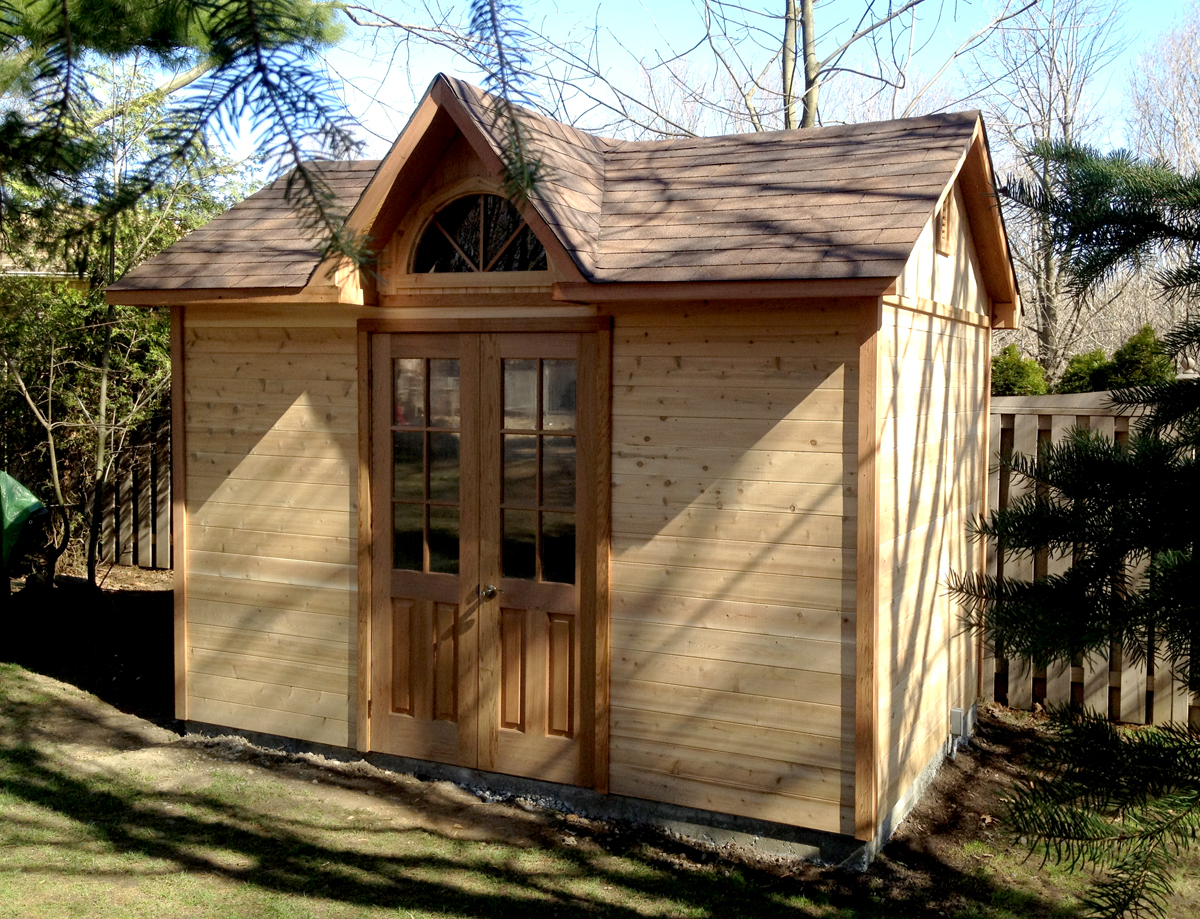 Cedar shed with French doors and an arched dormer window