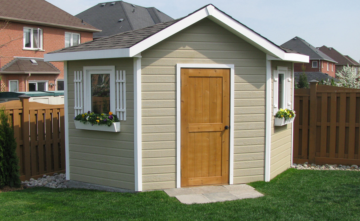 Painted shed with white trim and window boxes