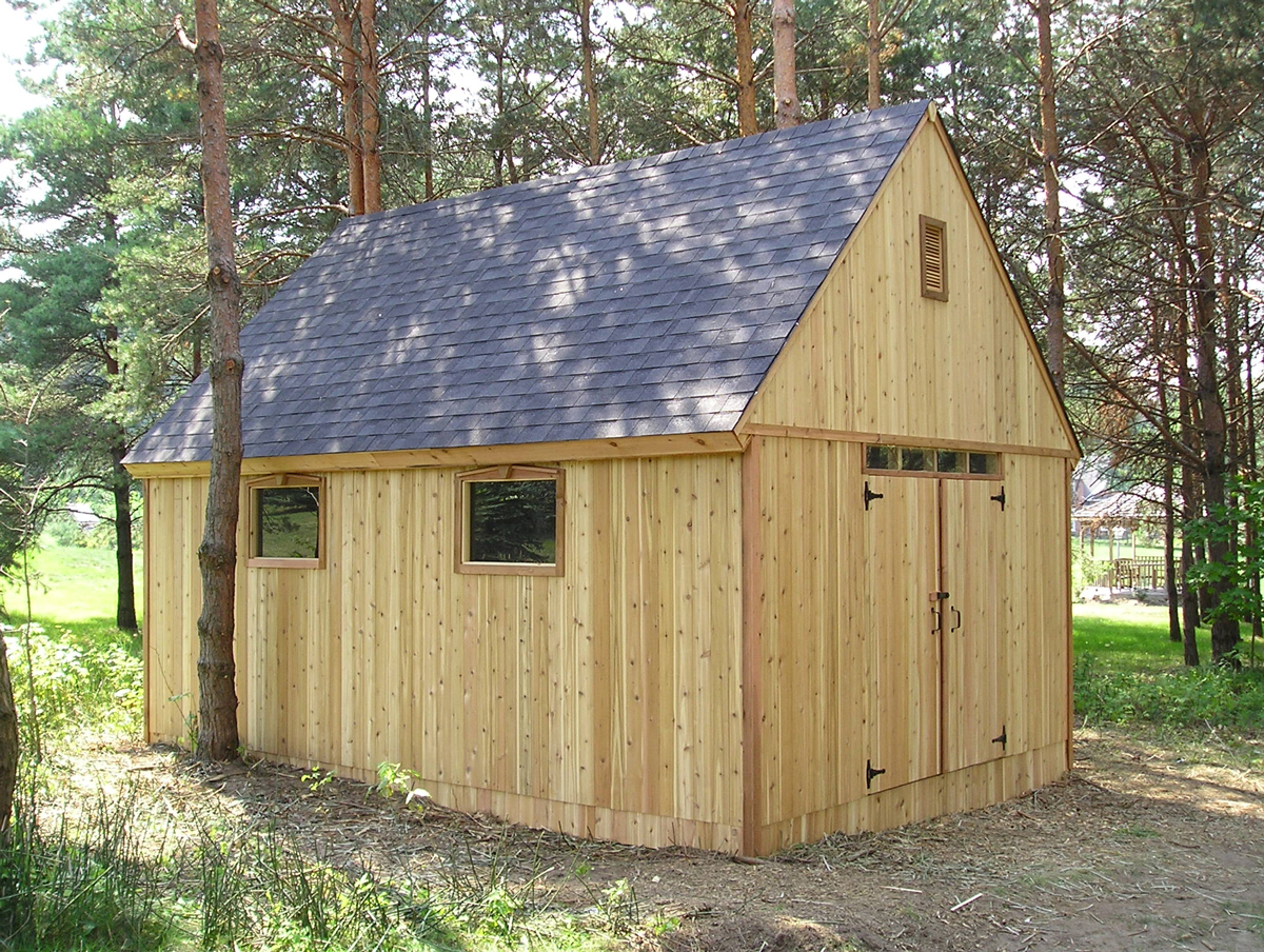 Large cedar outbuilding with a steep gable roof and double doors