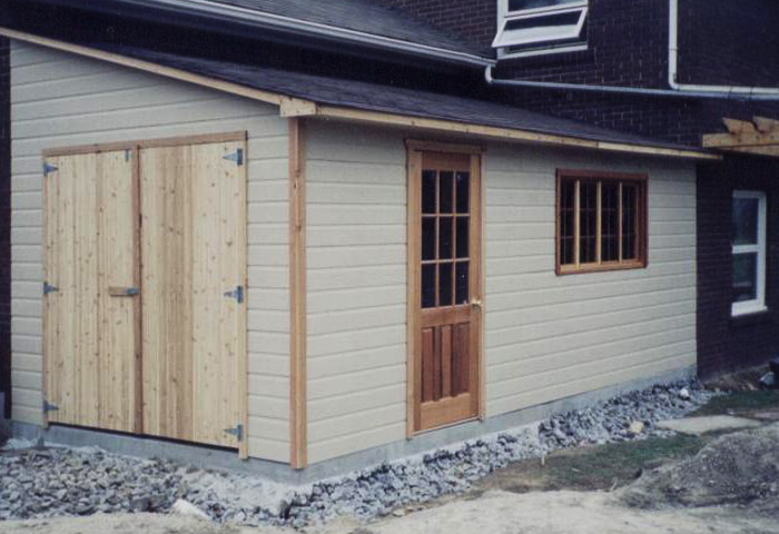 Garage addition with cedar swing doors and a cedar entry door
